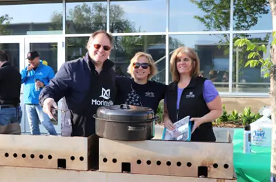 3 people smiling at pancake breakfast event