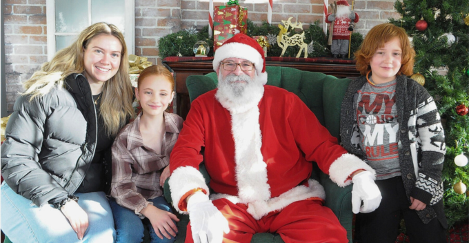 family pictured with Santa Claus