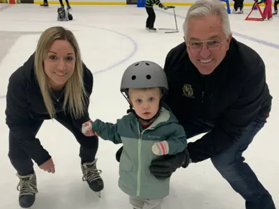 family on ice skates in an indoor arena
